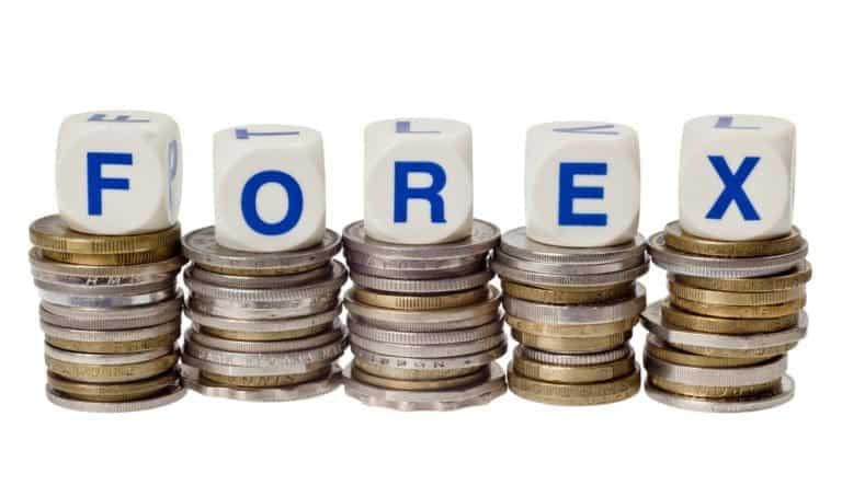 real time forex trading shown by Stacks of coins with the word FOREX isolated on white